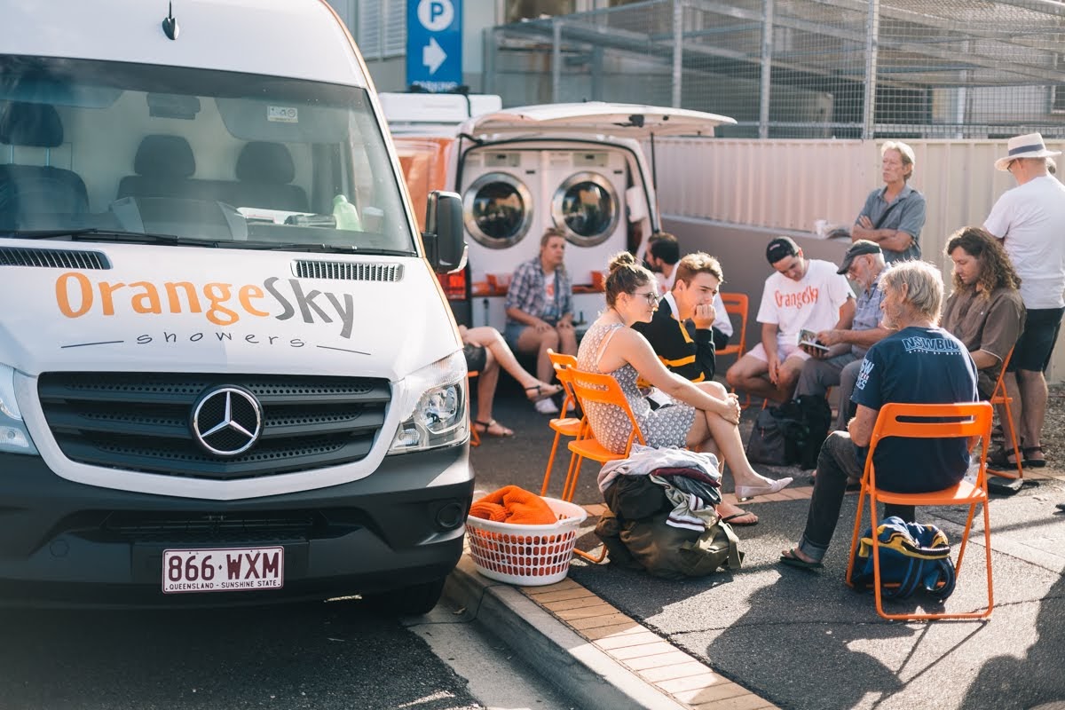 Some friends of Orange Sky Australia sitting on a circle of orange chairs in Fortitude Valley chatting